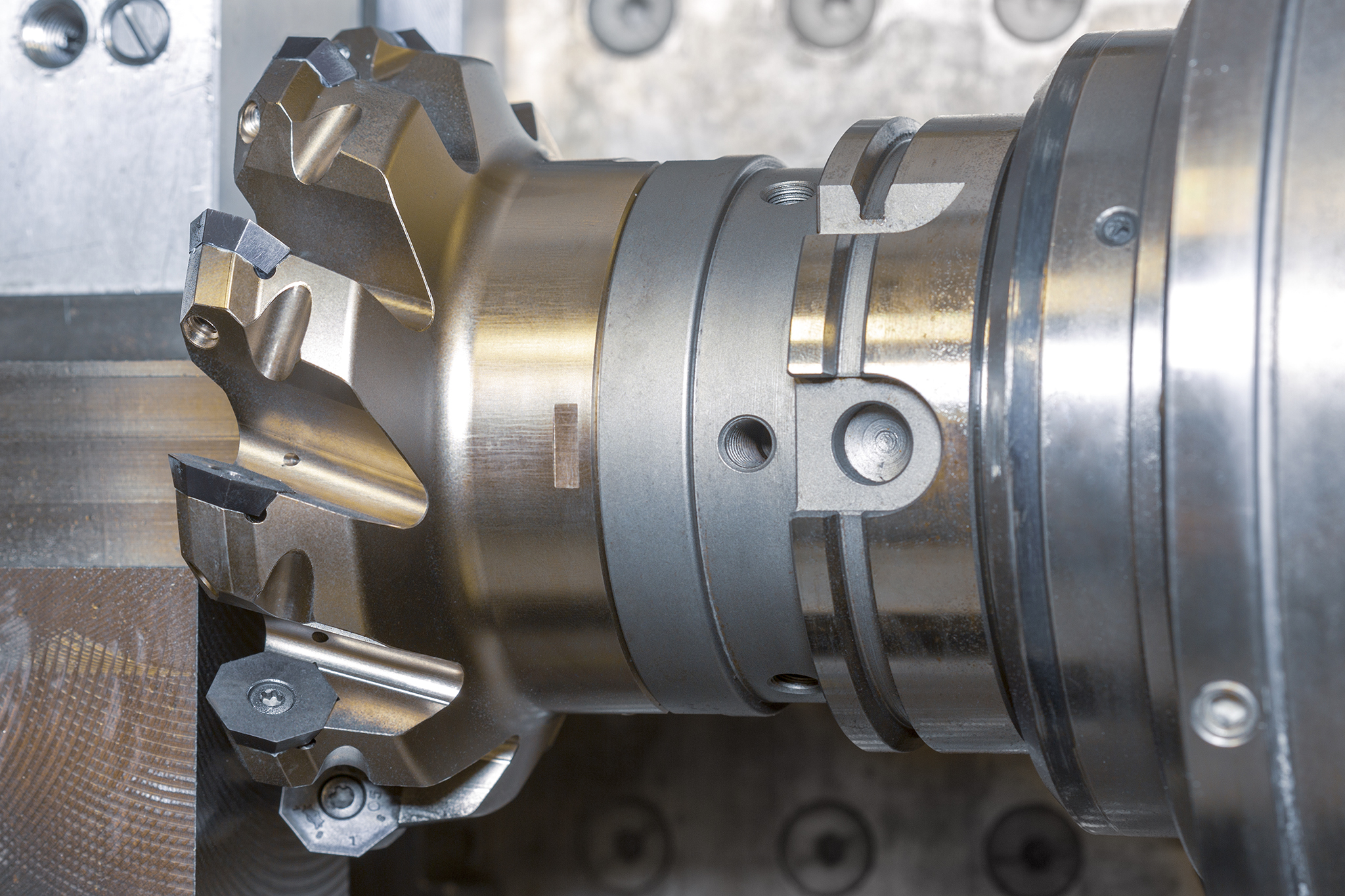 A milling cutter with radial indexable inserts in use in the machine. A milling cutter with radial indexable inserts in use in the machine.