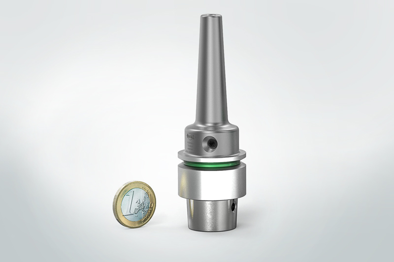 The small chuck is shown next to a 1 euro coin.