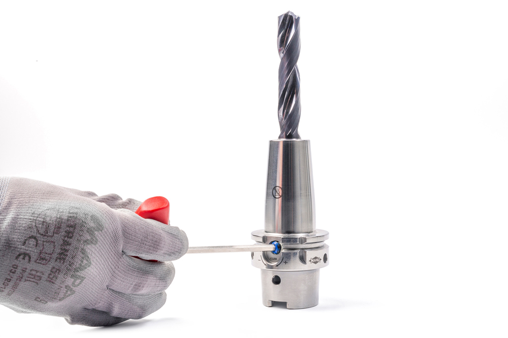 A solid carbide drill is clamped in a UNIQ hydraulic expansion chuck from MAPAL using a hexagonal key.