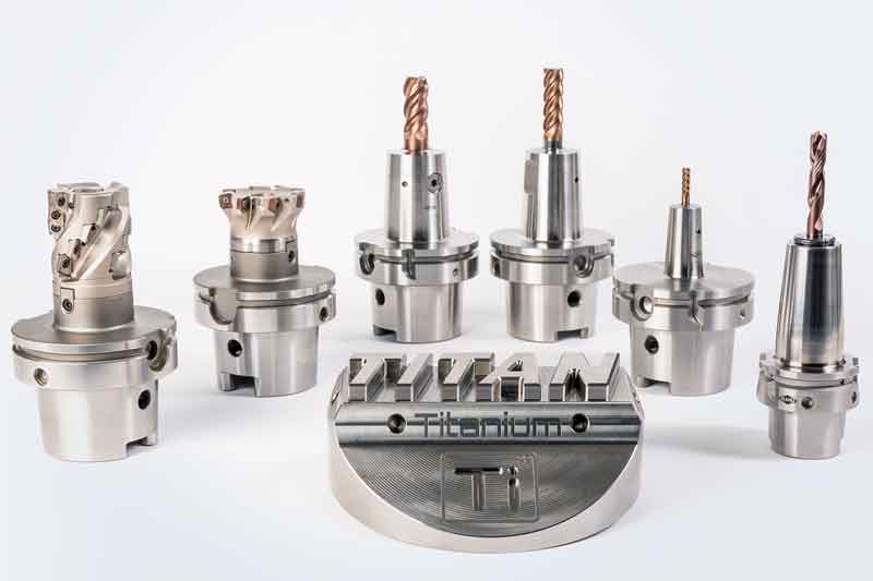 The picture shows different tools for titanium machining and an exemplary component.