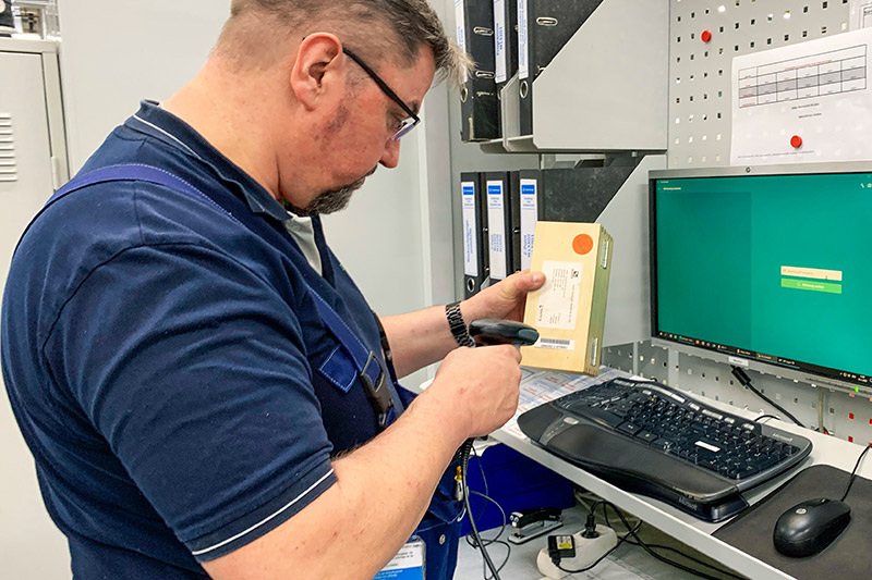 An employee scans a code on tool packaging.