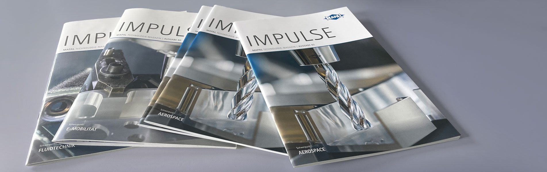 Several issues of the technology magazine Impulse are on top of each other