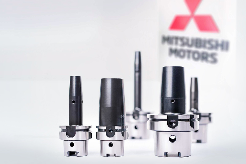 Five shrink chucks from MAPAL are placed in front of the Mitsubishi Motors logo.