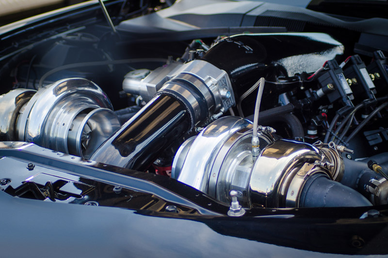 A view into the engine compartment of a car with turbocharger.